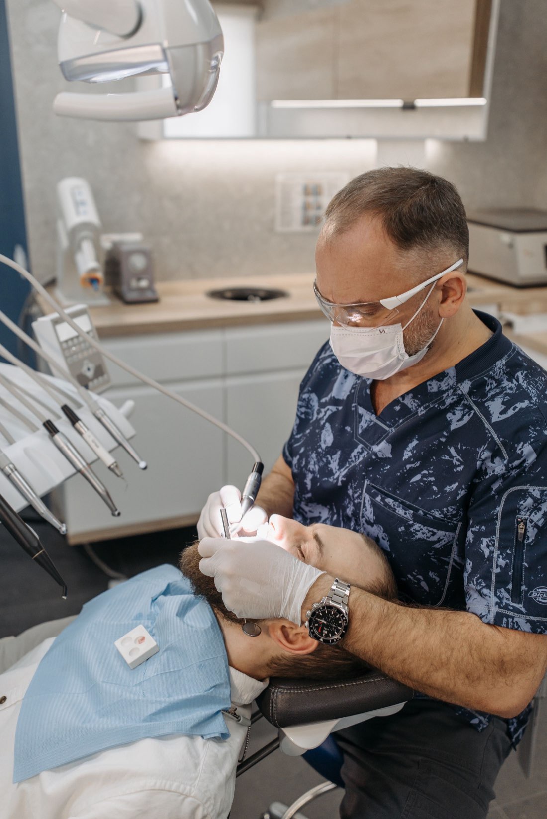 A dentist providing careful, attentive treatment to a relaxed patient