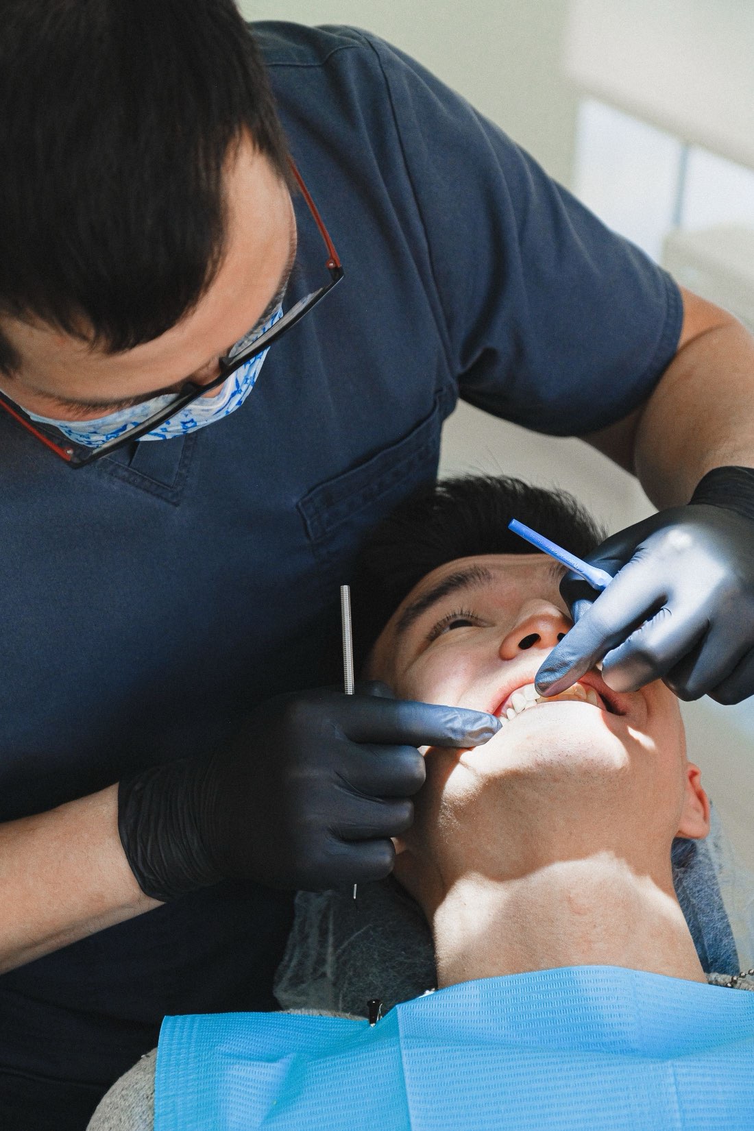 A patient receiving gentle, unhurried dental care in a calm, clean treatment room