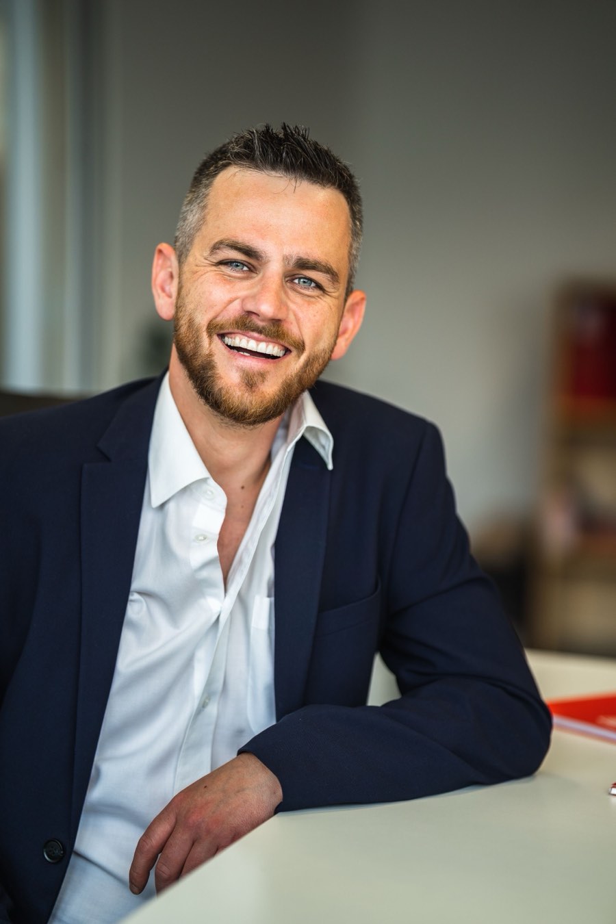 A confident adult smiling naturally (illustrative)